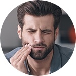 Man in pain holding his cheek