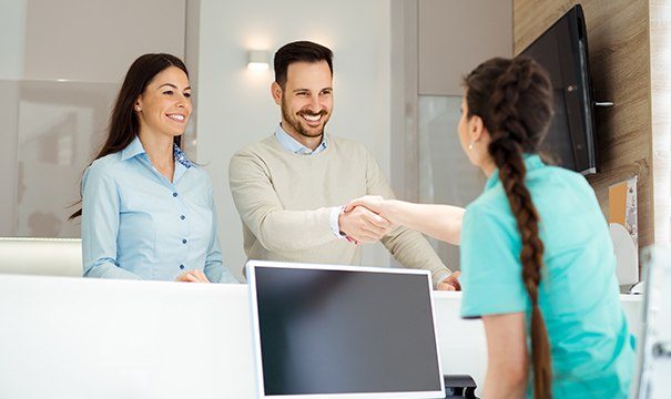 Man and woman checking in at dental office