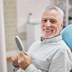 a patient smiling after getting dental treatment in Newton