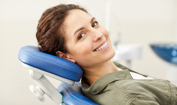 Female patient smiling after receiving treatment for toothache