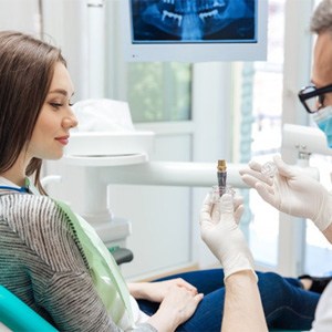 a dentist explaining how dental implants work