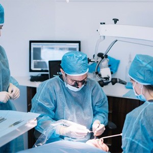 an oral surgeon performing dental implant placement