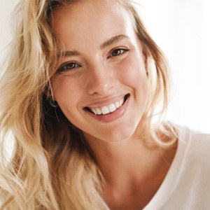 Close-up of a young blonde woman smiling