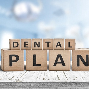 “Dental plan” written on wooden blocks, resting on tabletop