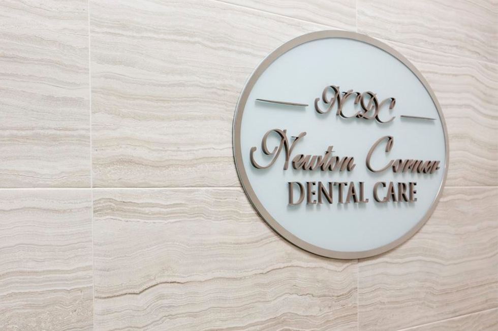 Newton Corner Dental Care sign on wall