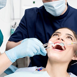 Woman smiling during dental cleaning with dentist in Newton