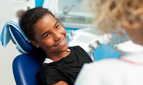 Smiling young girl in dental chair