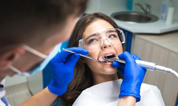 A woman receiving a root canal in Newton