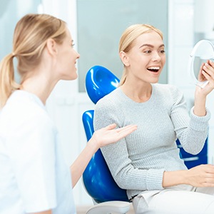 Cosmetic dentist in Newton speaking with a smiling patient