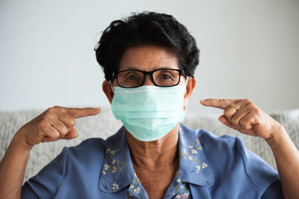 An at-risk patient wearing a mask at the dentist