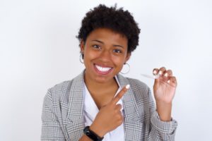 woman happy with her Invisalign aligners