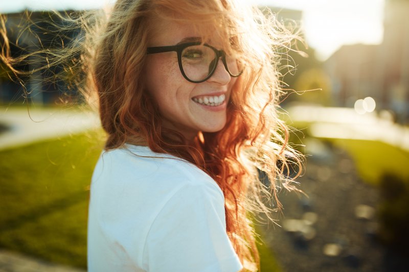 young woman smiling outside