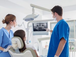 dentist showing a patient their dental X-rays 