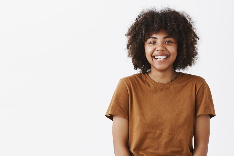 teenager with dental implants smiling