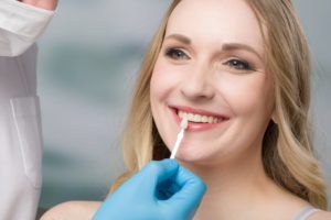 a woman getting veneers placed at the dentist